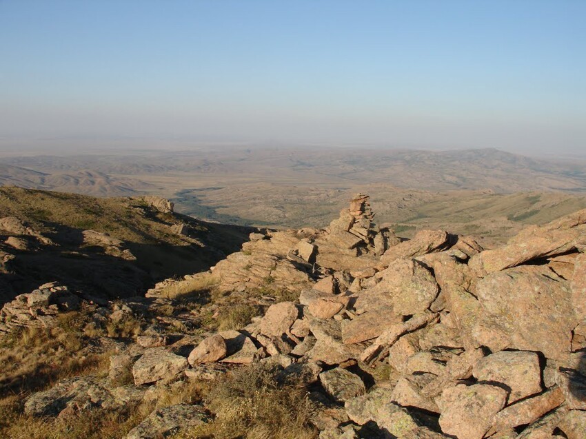 Aksoran Peak is the highest point of the Kyzylarai Mountains and the Kazakh Uplands (Saryarka) in general, with an elevation of 1,565 meters. The panorama of the mountain-steppe oasis opening from the summit is well worth the climb of approximately 600 meters.  From Aksoran Peak, one can overlook the surroundings for up to a hundred kilometers, and a keen observer can spot the contours of the Bektau-Ata Mountains on the horizon, located 120 kilometers away. The Kyzylarai Mountains are considered the largest habitat of Argali (mountain sheep) within the territory of Kazakhstan.  The local pine forests growing on granite rocks are of interest to scientists as the most abundant pine-growing site in the Central Kazakhstan ecosystem bordering the desert. The Kyzylarai Mountains are distinguished by their pristine nature.